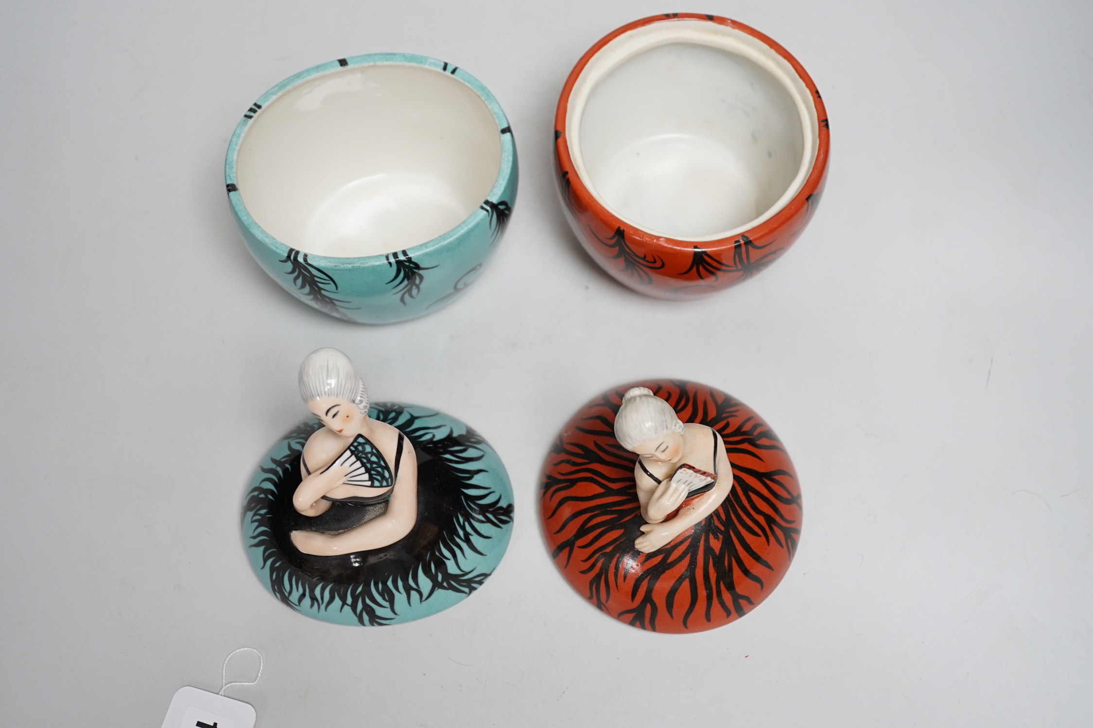 A 1930’s Robj figural ‘dancer’ powder bowl and cover and a similar powder bowl and cover, maker’s stamp on base, tallest 20cm